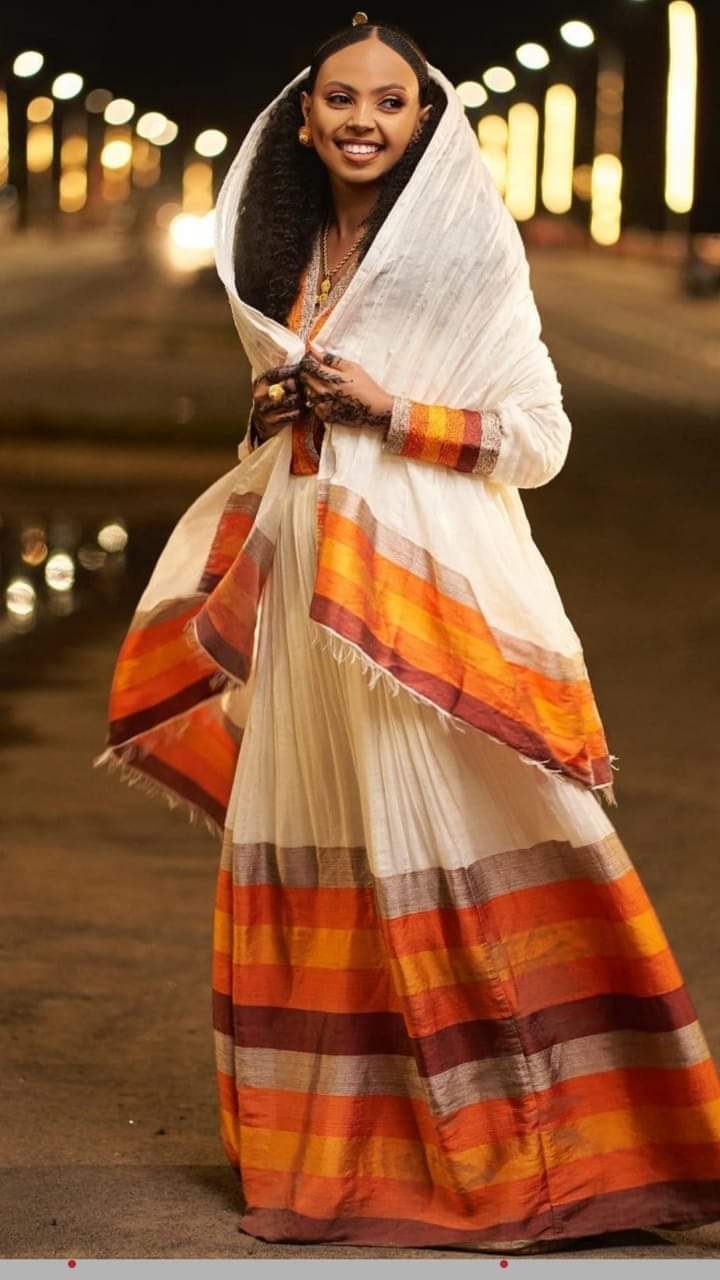 Woman wearing a traditional Habesha dress with a netela shawl